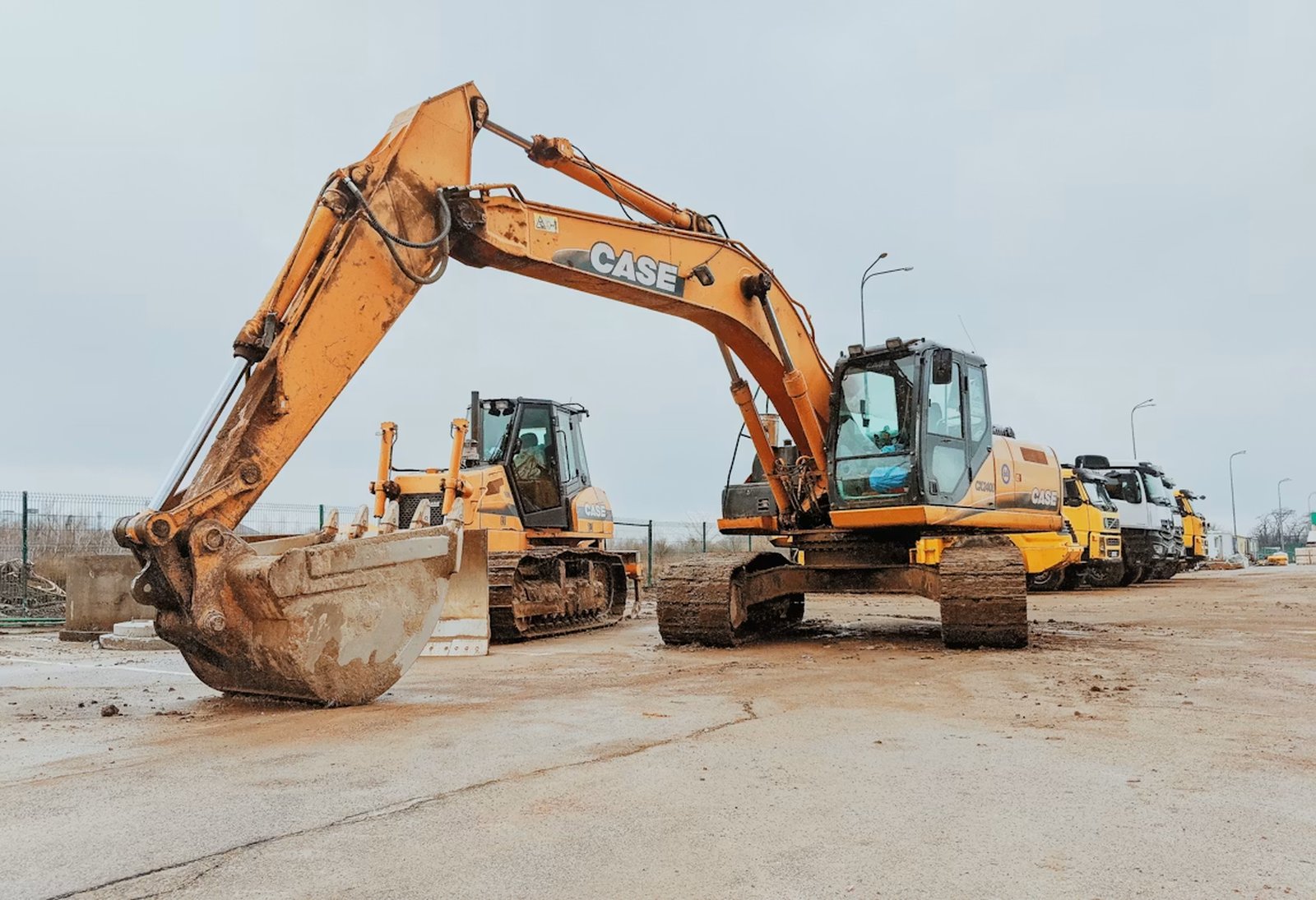 Used excavator and dozer in a European machinery yard, ready for export.
